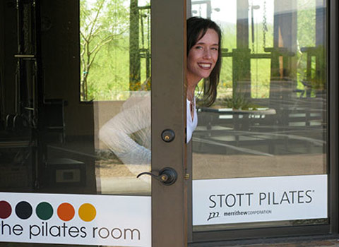 Picture of Kelly Richardson at the front door of The Pilates Room in Scottsdale, AZ